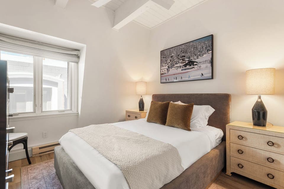 Primary bedroom with queen bed, ensuite bathroom, and tasteful decor.