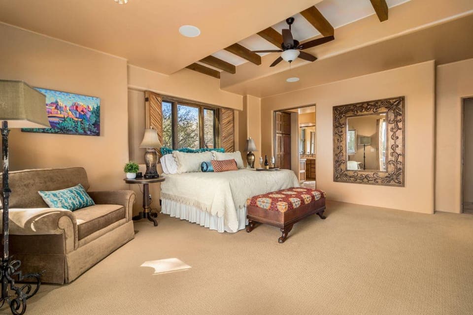 Large primary bedroom with exposed beams 
