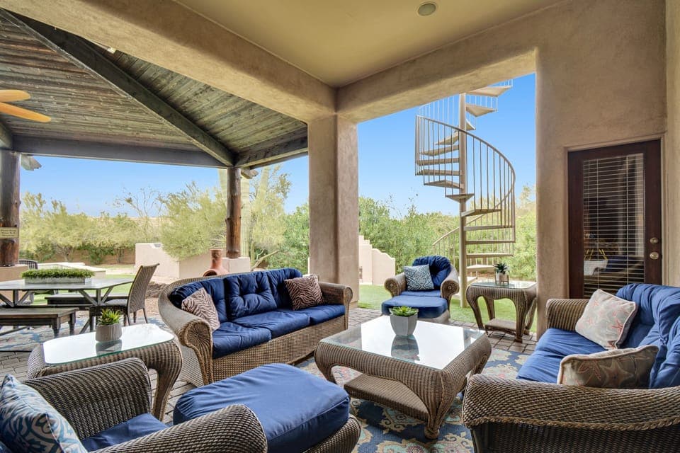 Patio seating with spiral staircase to rooftop deck 