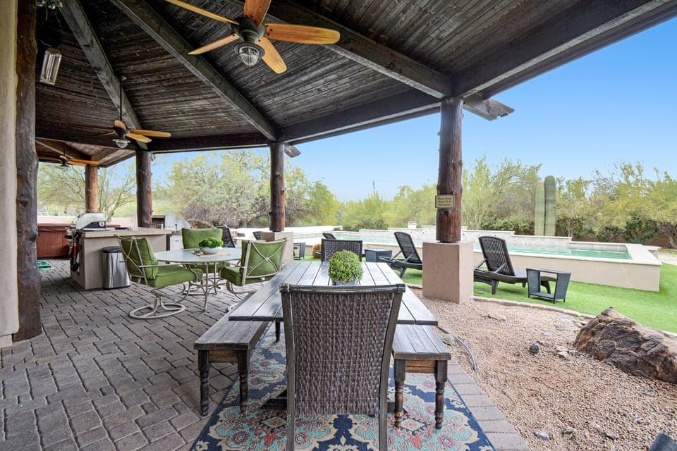 Covered patio with misters, fans, multiple seating options and outdoor tv