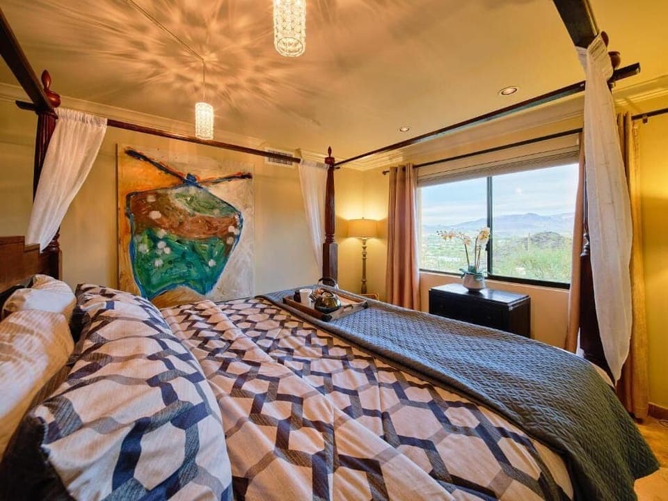The main bedroom with a luxurious King Bed and views of the hills and the desert