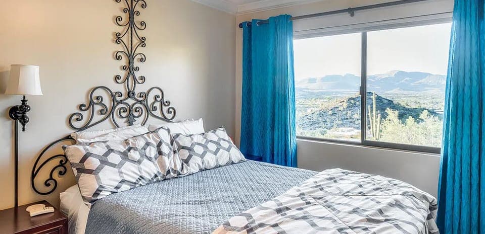 Bedroom #2 has a lovely soft queen bed with a view of the desert landscape 