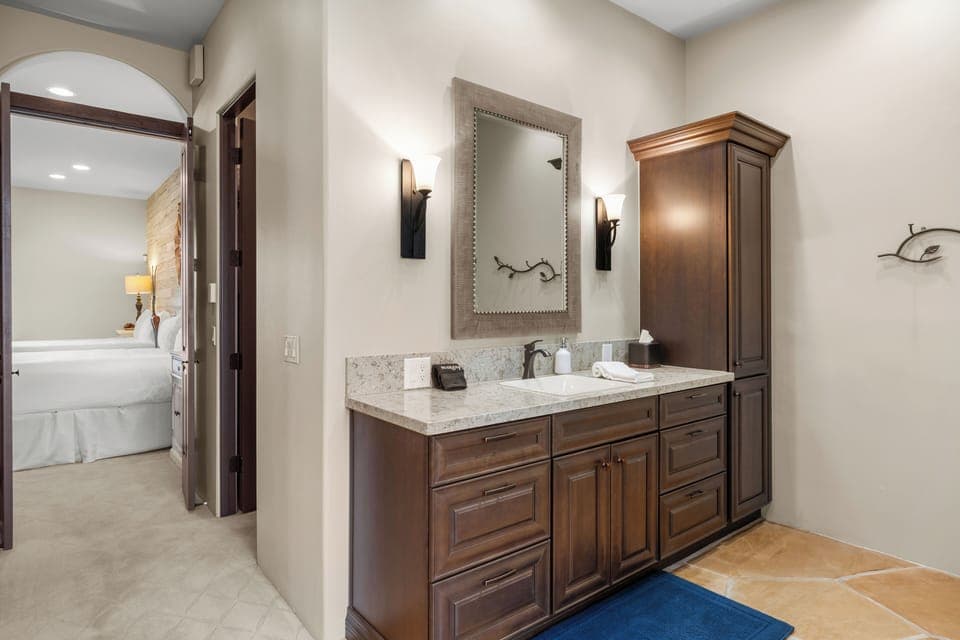 This expansive primary bedroom's ensuite features a soaking tub, separate shower and ample counter space. 
