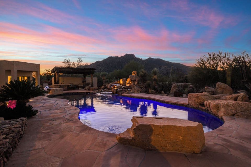 Sunset magic over the glowing desert pool—your private sanctuary at dusk.