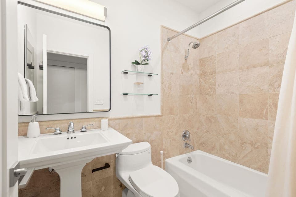 Ensuite primary bathroom with tub/shower combo.