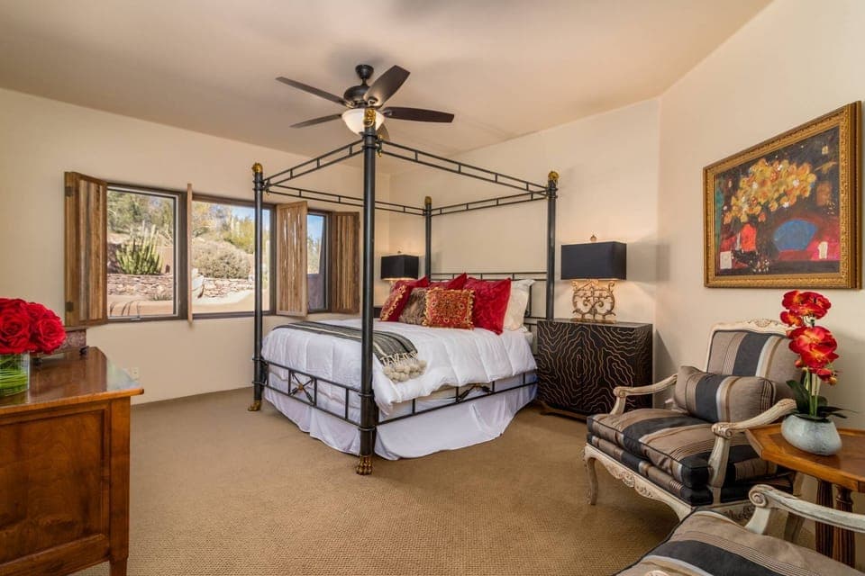 Large bedroom with canopy bed and sitting area