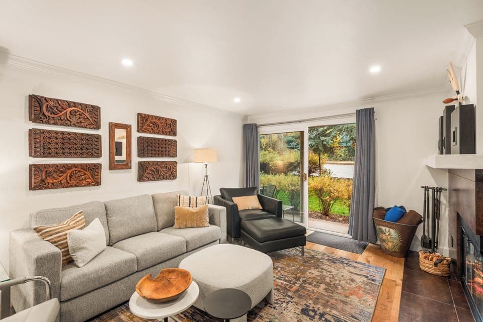 Living room with private porch with Aspen Mountain views, wood-burning fireplace, smart TV, and sofa bed.