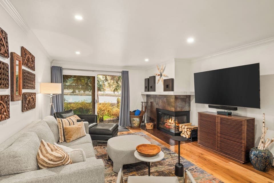Living room with private porch with Aspen Mountain views, wood-burning fireplace, smart TV, and sofa bed.