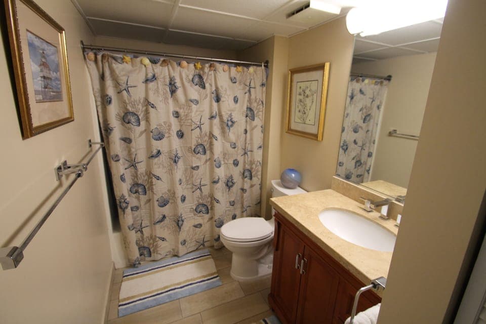 Remodeled bath with new ceramic floor, cabinet, top and toilet. 
