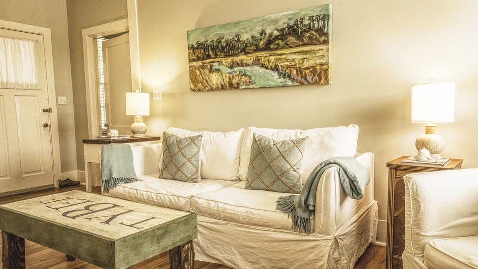 Living Room - This cozy living space features comfy seating and vibrant original art from local Tybee artists, bringing a splash of island personality indoors.