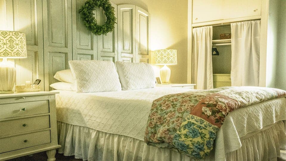 Queen Bedroom #1 - Queen bedroom #1 with private full bath with tub/shower combo, features a unique headboard, luxurious linens, and a large closet for storage.