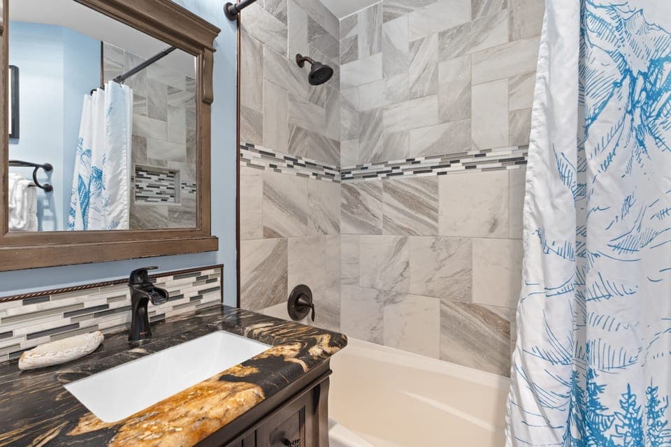 Refresh after your adventures in this beautifully tiled bathroom. Soothing neutral tones and a spacious tub-shower combo offer a tranquil spot for you to unwind.