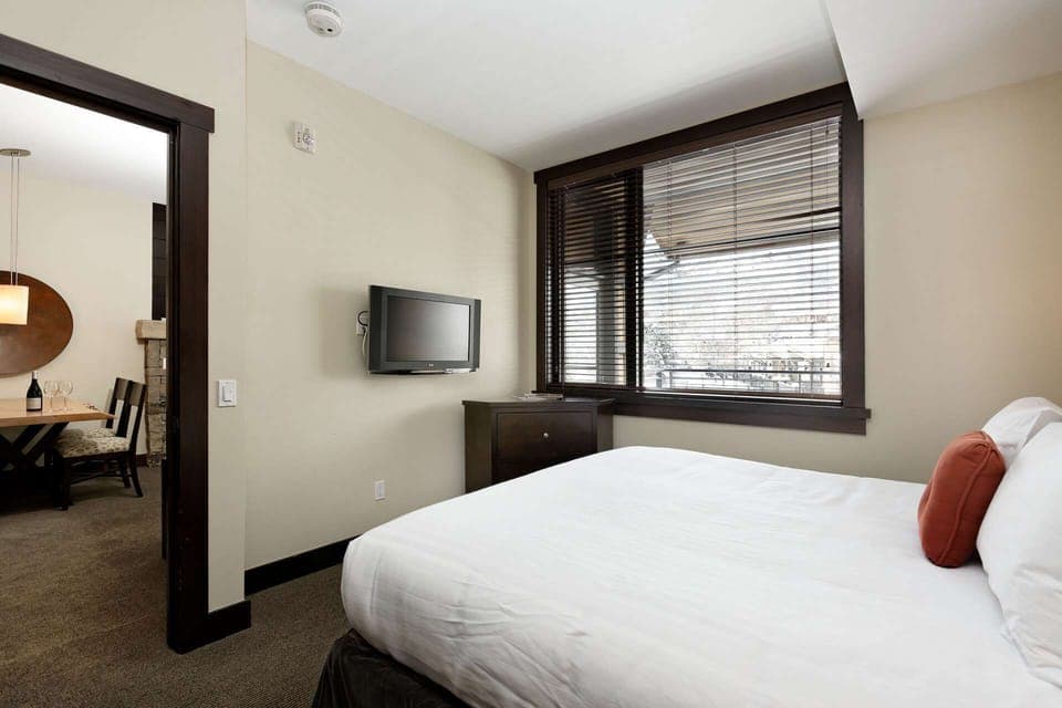The private bedroom features a king bed and a flat screen tv.