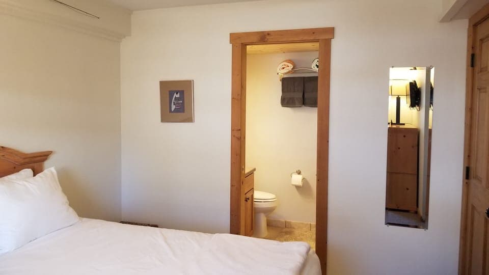 Bedroom 2: queen bed with Winkbed mattress, ceiling fan, and master bath