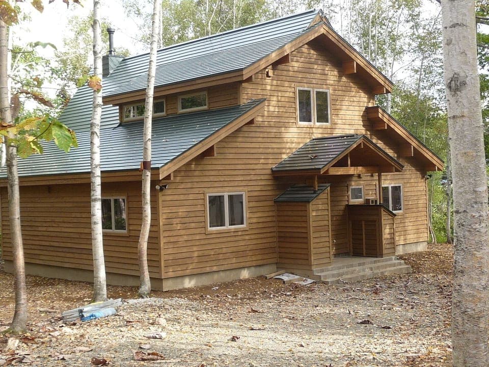 Entrance with ski/snowboard equipment closet and firewood storage.