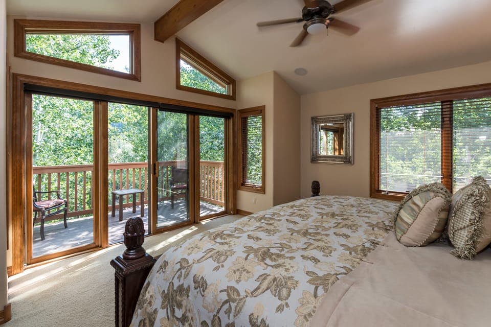 Primary bedroom w/deck overlooking the River! King bed, luxury bedding & TV!

