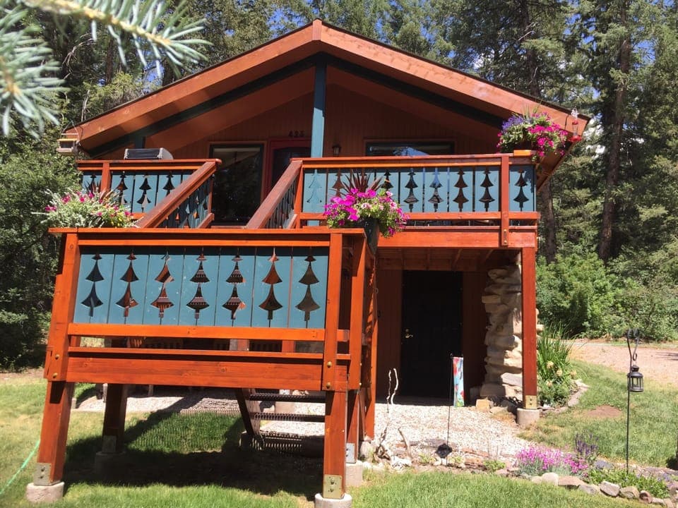 Has a beautiful front porch with flowers on the stair way
